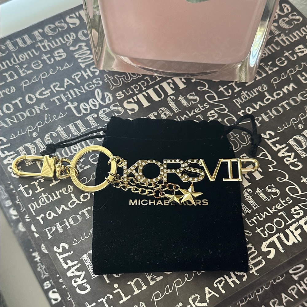 Micheal Kors VIP bag charm in gold hardware.